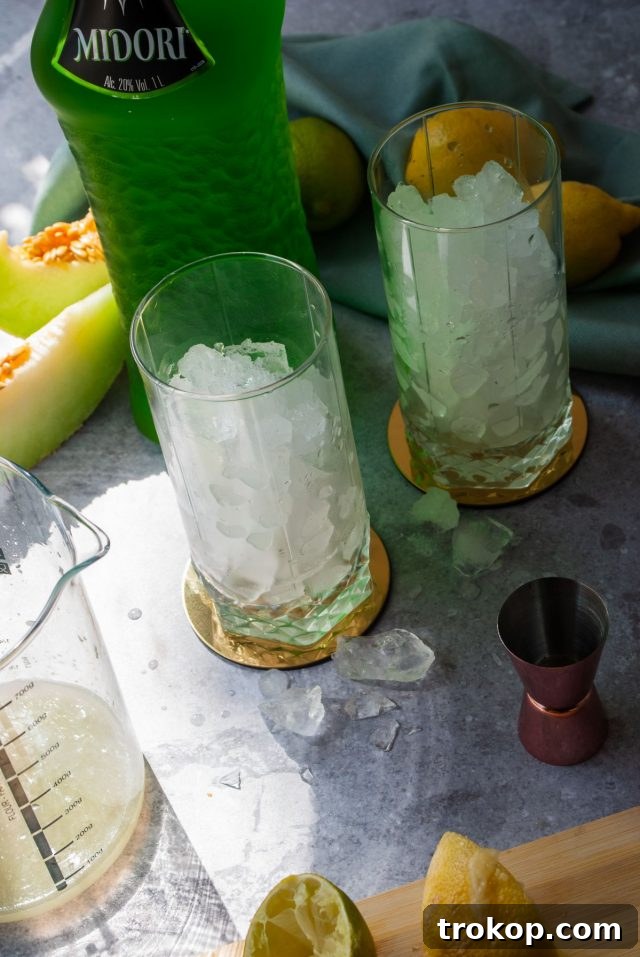 Refreshing Midori Sour Cocktail 6 Midori Sour Recipe - two tall glass full of ice