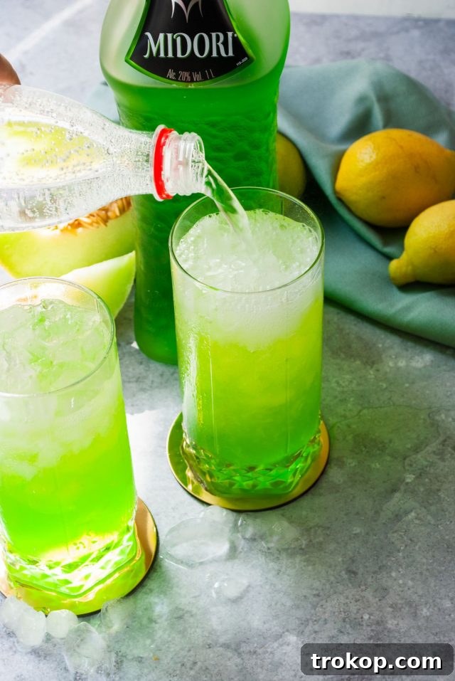Refreshing Midori Sour Cocktail 7 midori sour recipe - splashing soda on the midori sour drink