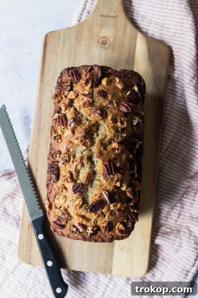 Bowl of mashed overripe bananas with sugar and other wet ingredients.