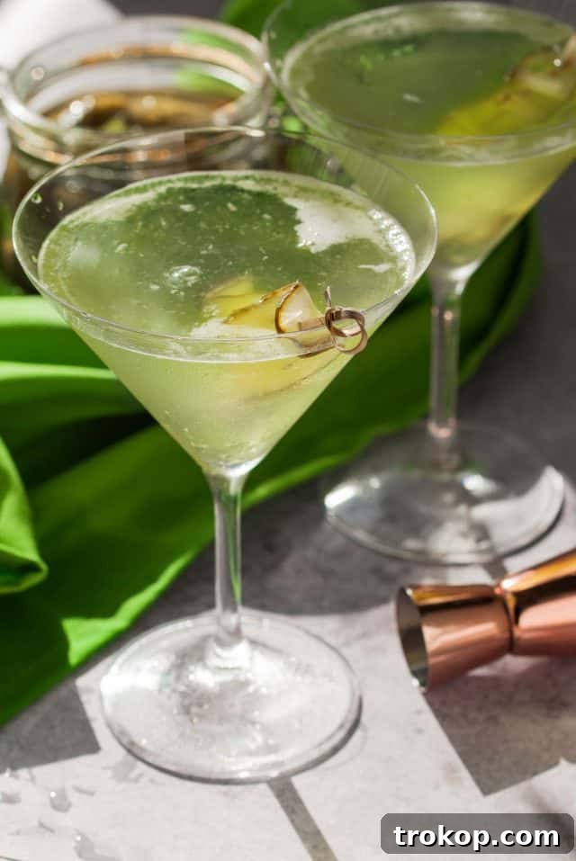 Pickle Martini cocktail, garnished with a pickle spear, presented in a classic martini glass.