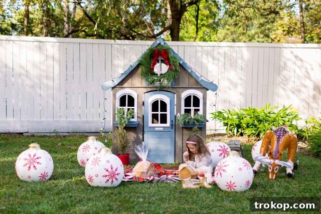 A child joyfully decorating a gingerbread house kit, with festive supplies around