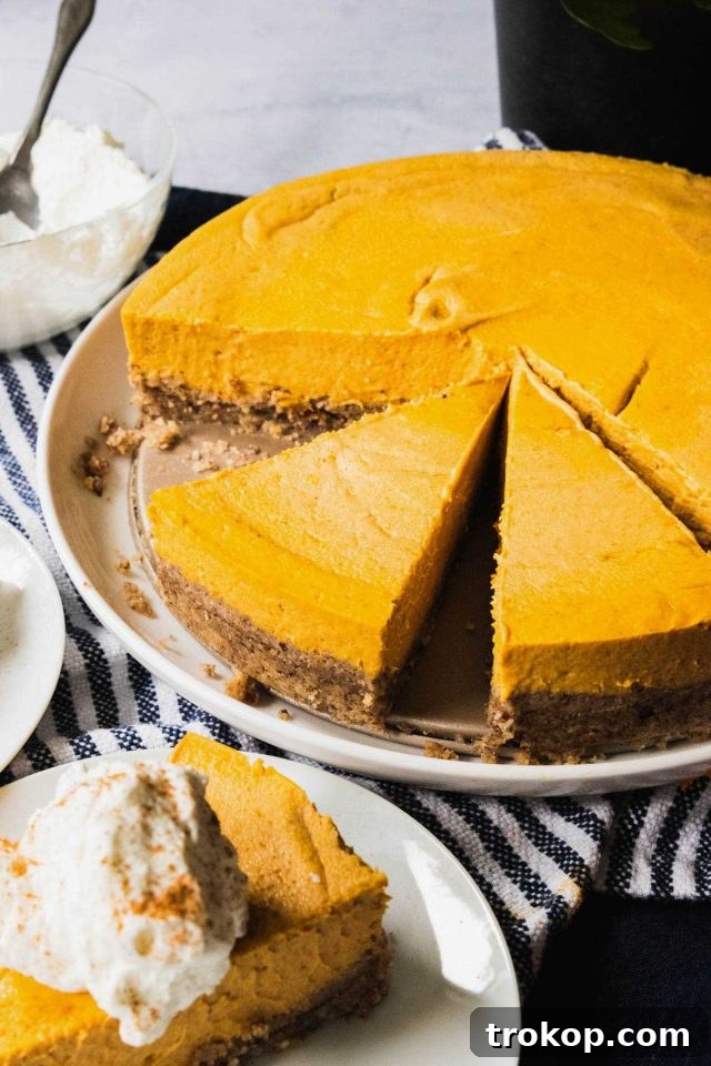 keto pumpkin desserts - slicing a piece of cheesecake