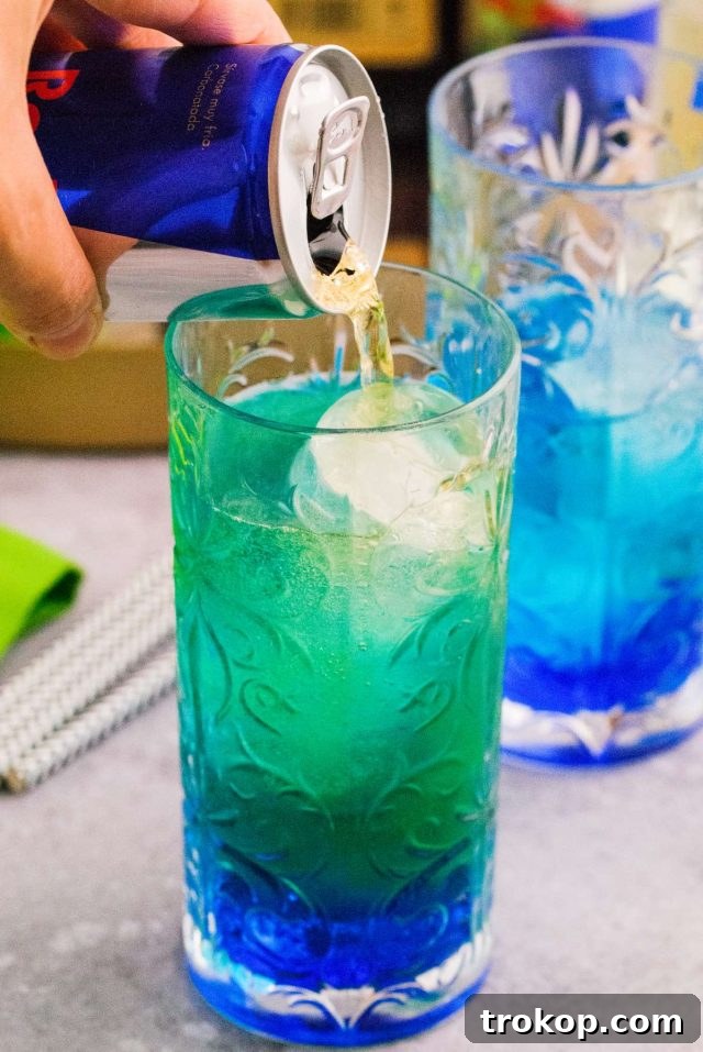 Irish Power Surge Cocktail Recipe 4 irish trash can drink - pouring redbull drink in the glass