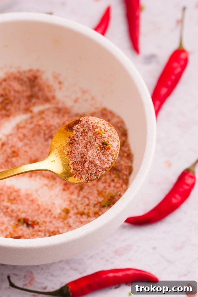 Ingredients for a sweet Tajín-inspired rim for Mexican candy shots, mixed in a spoon.