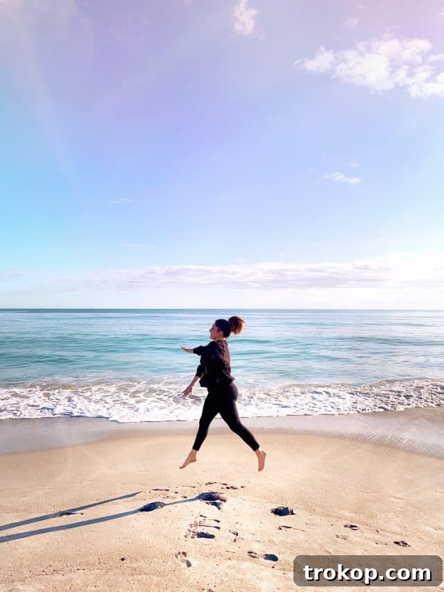 Cultivating Healthy Accountability 2 Ashley jumping on a serene beach, symbolizing freedom and the beginning of a new journey