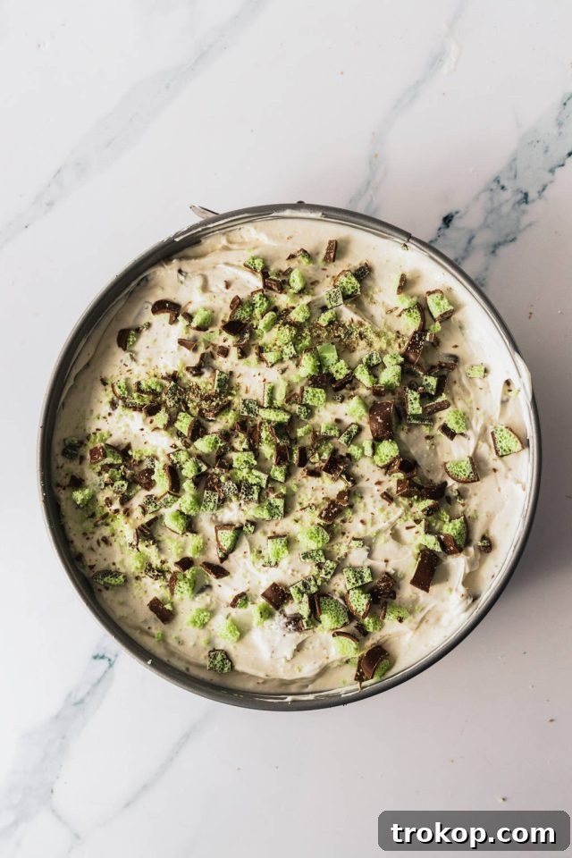 Top-down view of the Mint Aero cheesecake with chopped Aero pieces sprinkled on top
