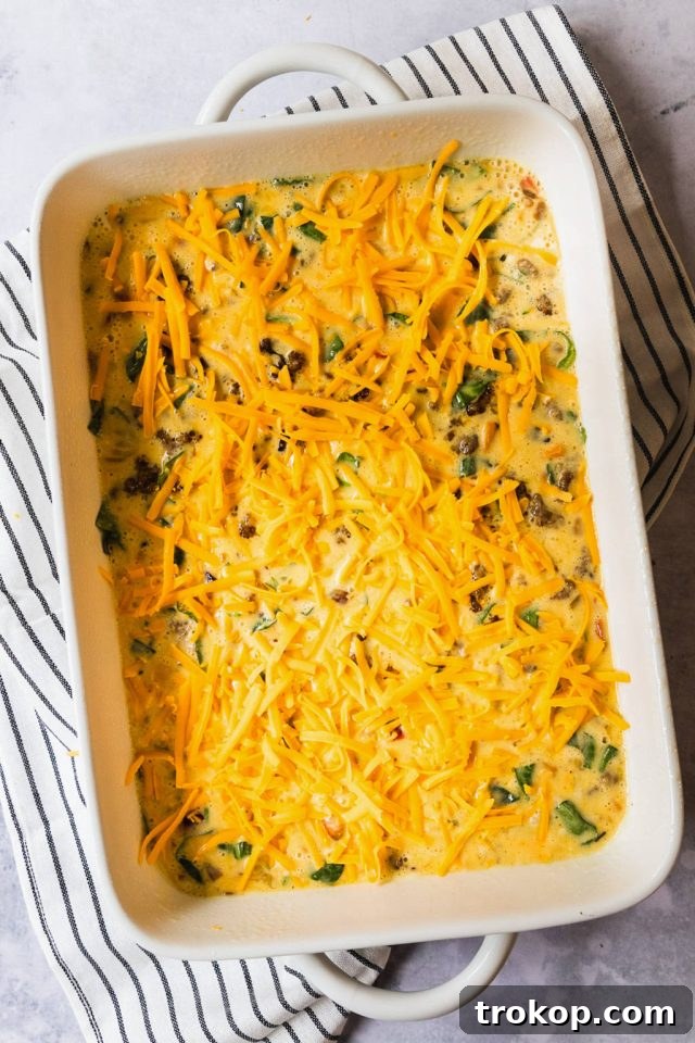 Ultimate Healthy Keto Breakfast Casserole 7 keto breakfast casserole mixture in a baking dish