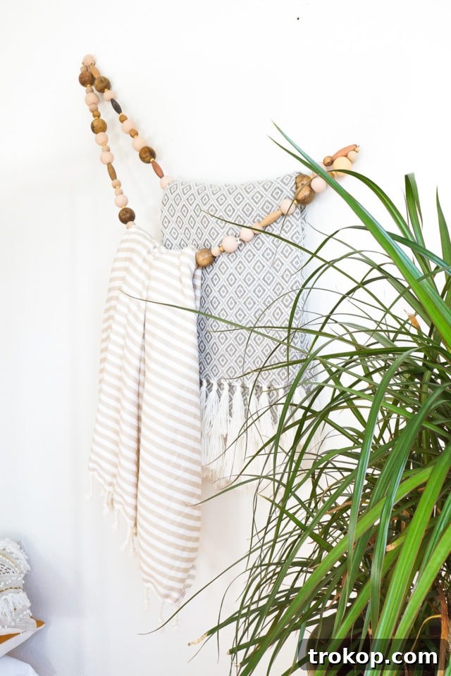 25 Dreamy Bedroom Ideas Little Girls Will Adore 20 DIY Minimal Beaded Blanket Holder by top Houston lifestyle blogger Ashley Rose of Sugar and Cloth
