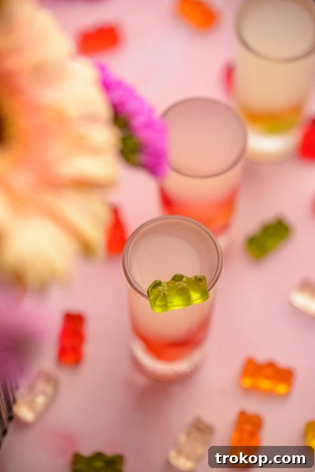A single glass of delicious Gummy Bear Shots, brightly lit and ready to be enjoyed