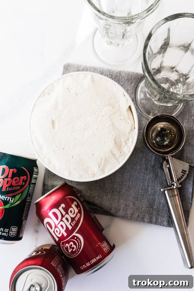 Decadent Homemade Dr. Pepper Vanilla Float 3 Ingredients used to make Dr. Pepper Vanilla Float, including vanilla ice cream, Dr. Pepper soda, and a bowl of fresh whipped cream