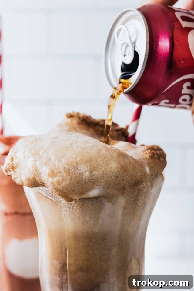 Decadent Homemade Dr. Pepper Vanilla Float 6 Pouring chilled Dr. Pepper over vanilla ice cream, creating a foamy float effect