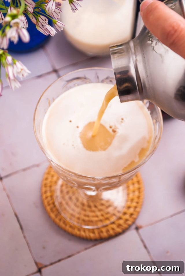 Effortless Brandy Alexander Elegance 5 Pouring Brandy Alexander into a chilled coupe glass