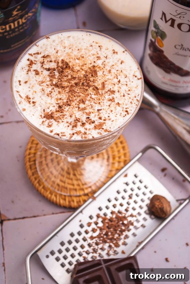 Effortless Brandy Alexander Elegance 6 Garnishing a Brandy Alexander with freshly grated nutmeg and dark chocolate