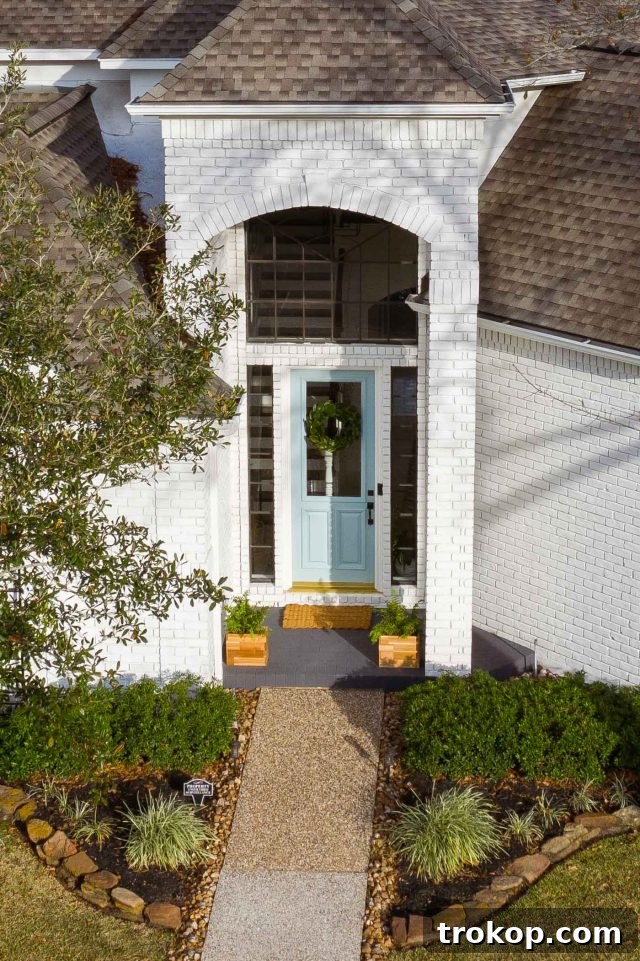Effortless Wall Paint Ideas for Every Interior 5 Drone photo of an updated exterior brick house entrance with limewash paint