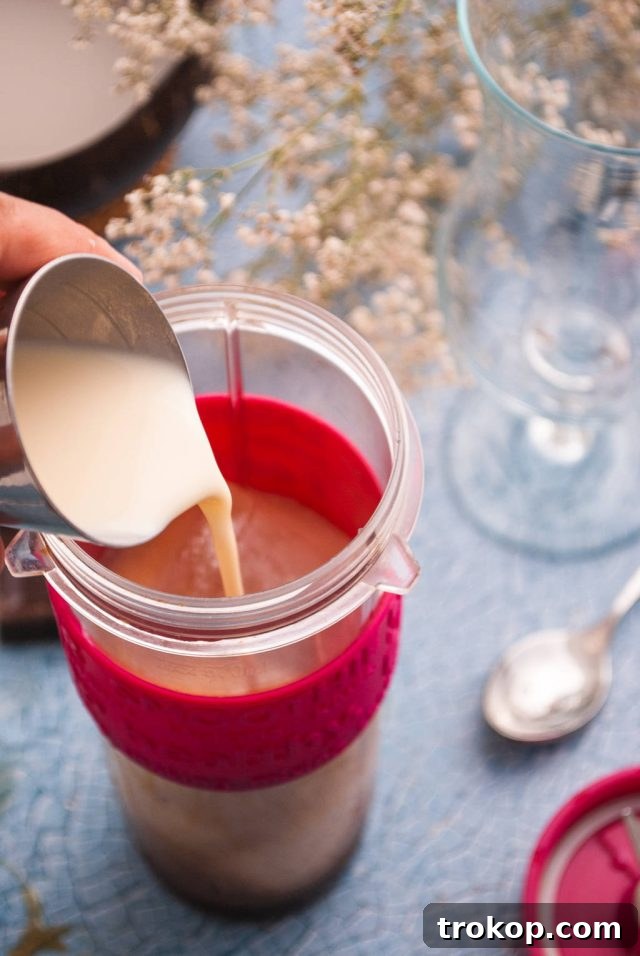 Bushwacker Recipe: Make Your Own Cream of Coconut Cocktail 5 Adding all liquid ingredients and ice into a blender to prepare the Bushwacker cocktail mixture.