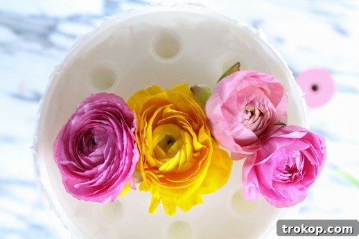 Your Fresh Floral Cake Masterpiece 7 Arranging fresh flowers in a cake vase for a DIY topper