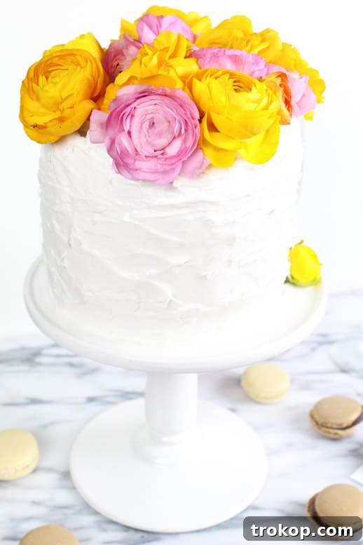 Your Fresh Floral Cake Masterpiece 8 Adding small filler flowers to a fresh flower cake topper