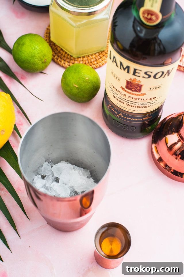 Adding ingredients to a cocktail shaker for the Green Tea Shot, showing the process of mixing.