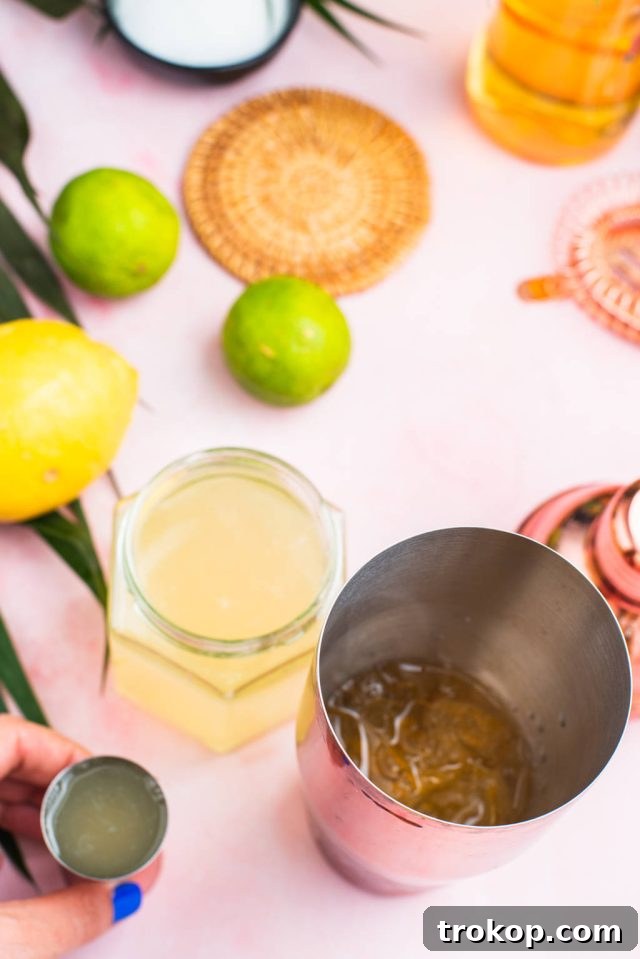 Pouring the sweet and sour mix into the cocktail shaker, a key step in preparing the Green Tea Shot.