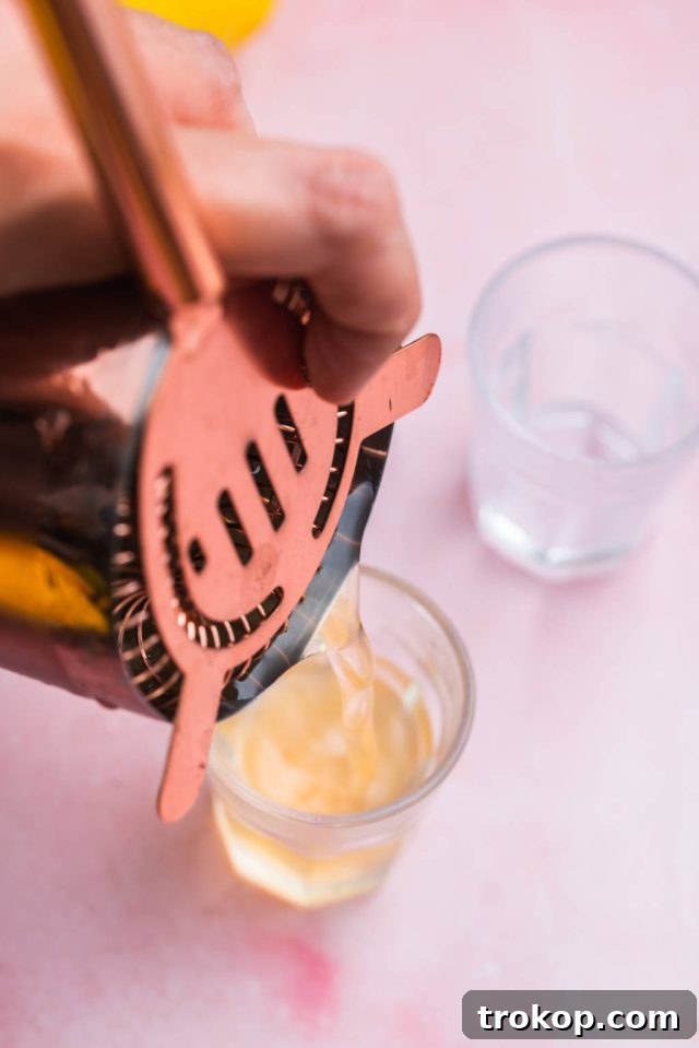 Serving the Green Tea Shot in a chilled glass, ready for the final touch.