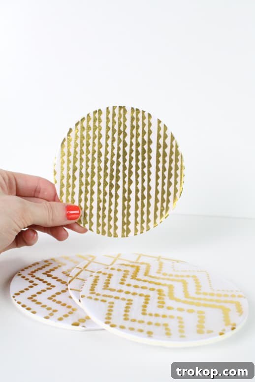 Crafting Water-Resistant Paper Coasters 6 Applying Dimensional Magic to a paper coaster, demonstrating the filling process.