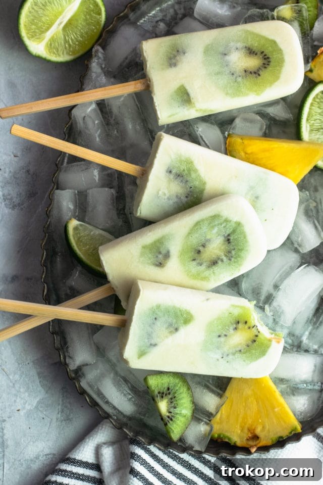 Whole 30 Tropical Popsicles Recipe Bite by top Houston lifestyle blogger Ashley Rose of Sugar & Cloth