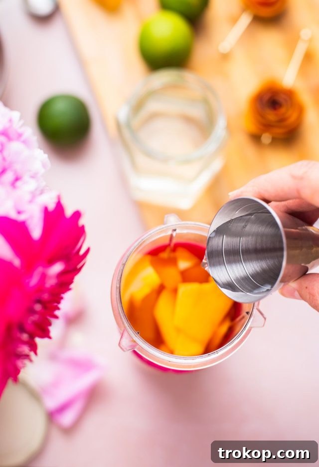 pouring white rum on the blender