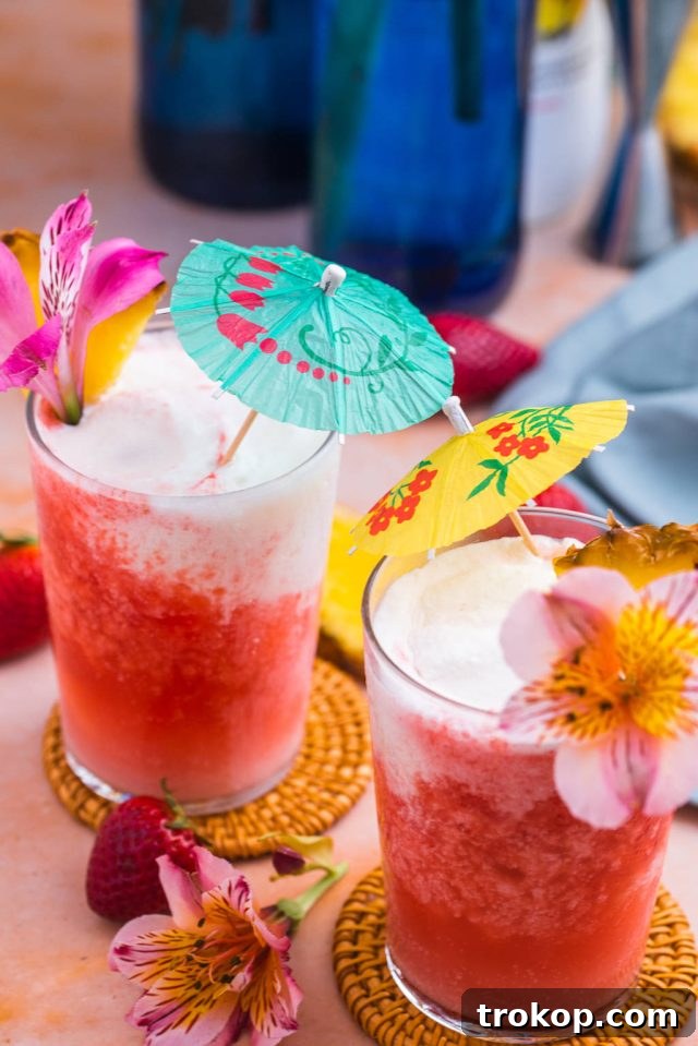 Hawaiian Heaven: 25 Effortless Island Recipes 10 Lava flow cocktail with a slice of pineapple and flowers as garnish