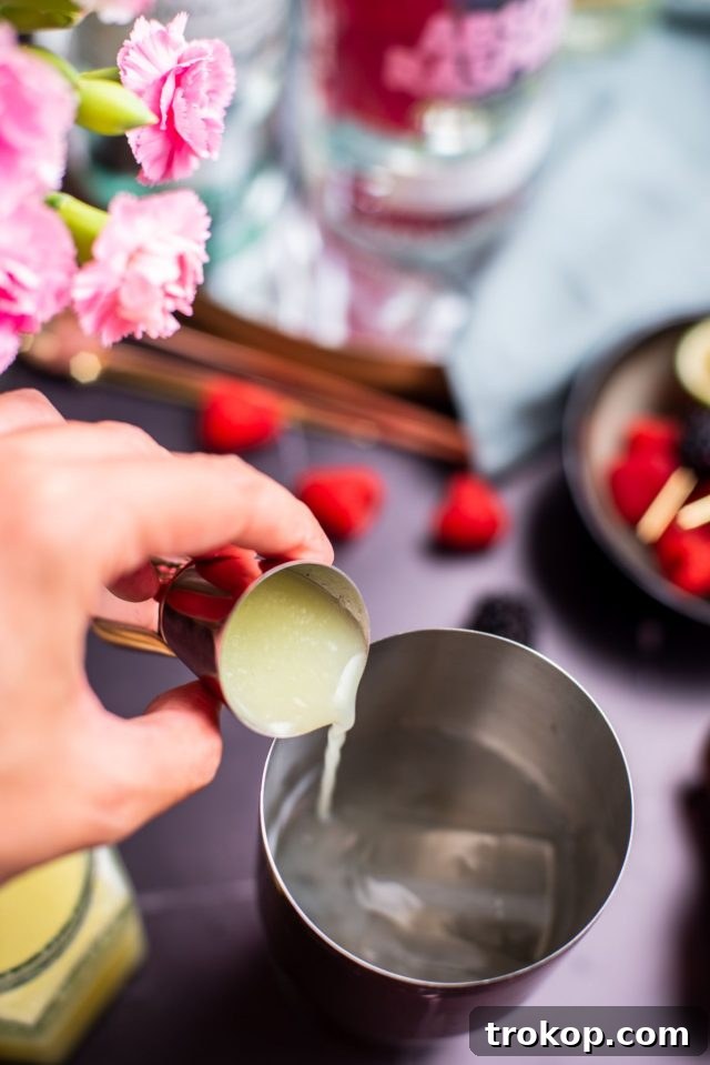 Sweet and sour mix being measured with a jigger