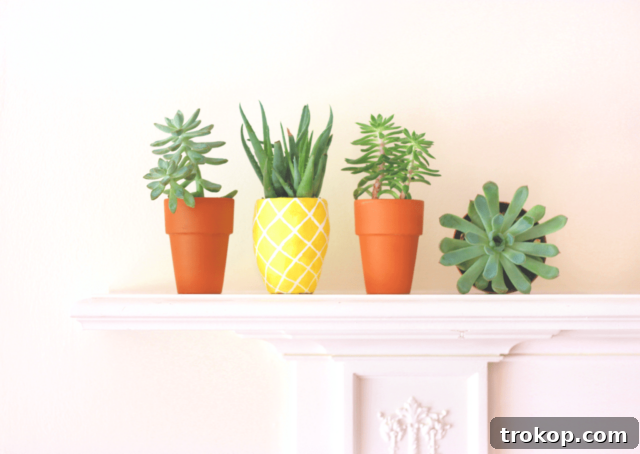 Crafting with Air Dry Clay 30 Ideas for Kids and Grown Ups 5 Pineapple Planter made from air dry clay, painted yellow with green leaves.