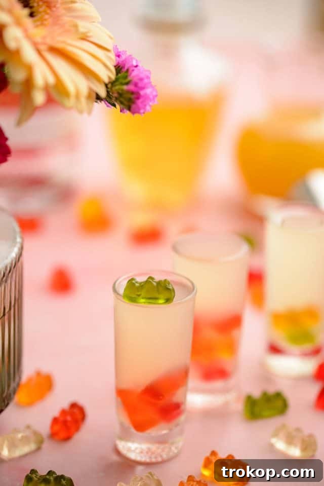 A glass filled with colorful gummy bear shots, showcasing the playful bears within.