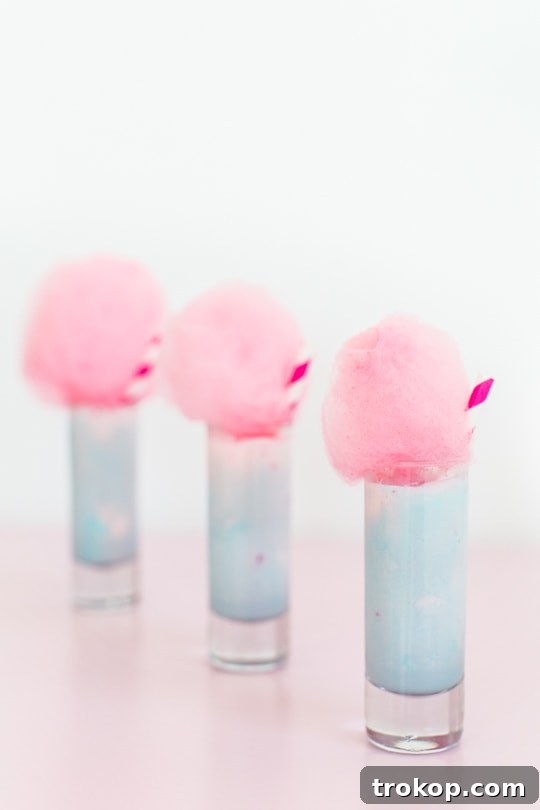 Colorful cotton candy ice cream shots, topped with fluffy cotton candy.