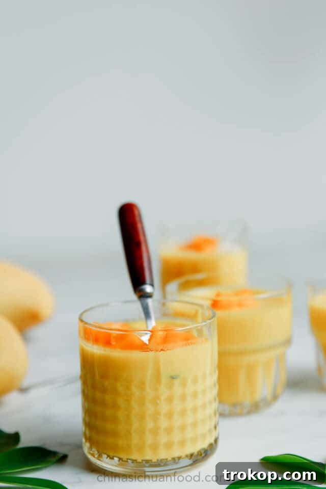 Chinese Mango Pudding, a vibrant yellow dessert with fresh mango cubes.
