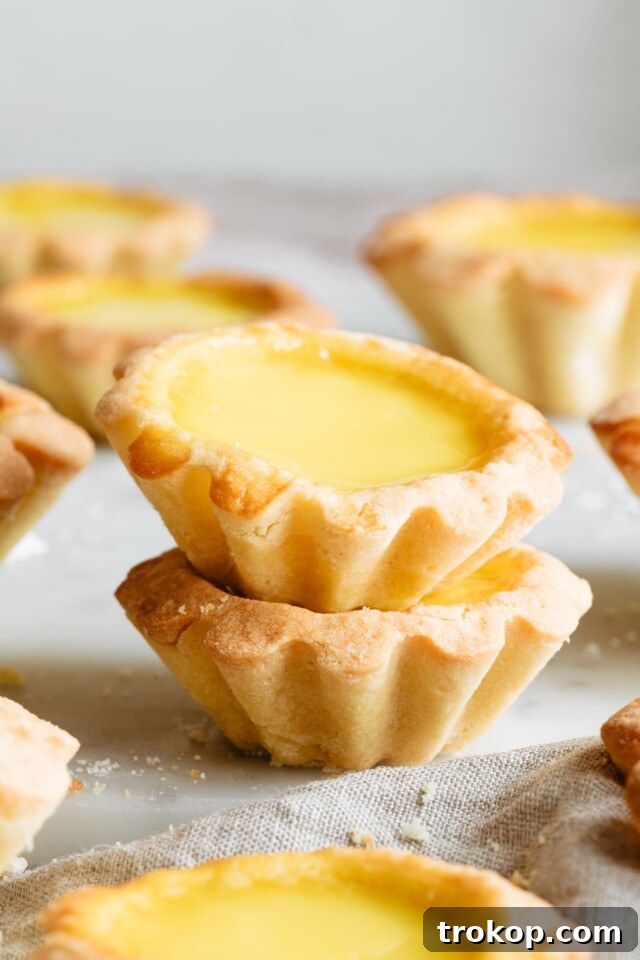 Chinese Egg Tarts Recipe, with a flaky crust and golden custard.
