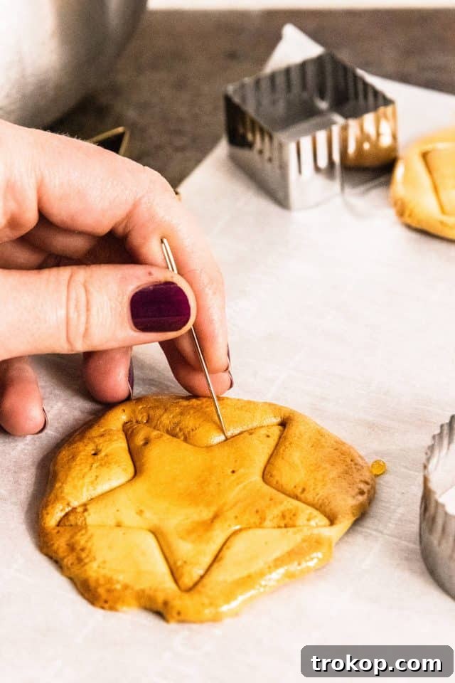 Releasing the star shaped Dalgona Candy with a needle, a popular Korean street snack.