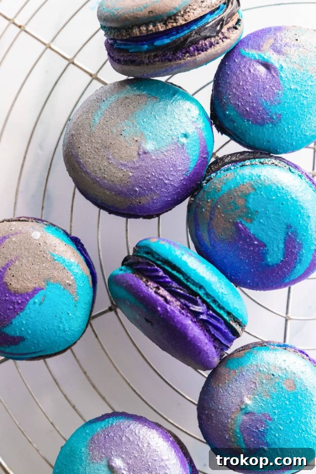 Cosmic Macaron Delights 3 A collection of beautifully decorated Galaxy Macarons, showcasing their unique swirls and shimmery finish.