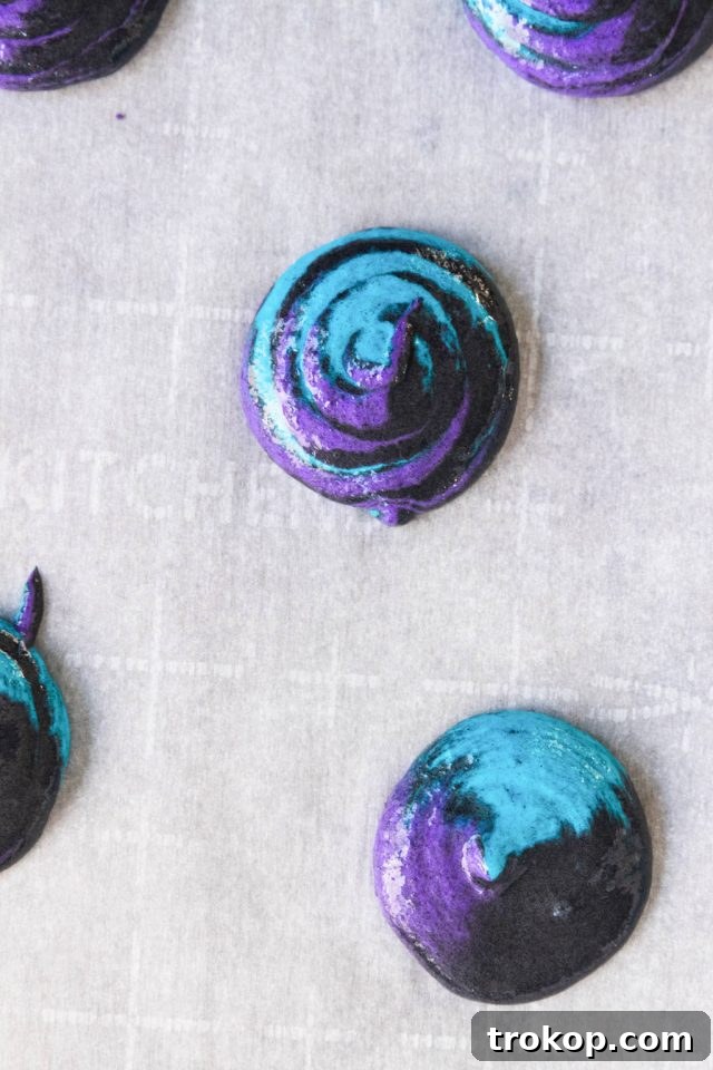 Cosmic Macaron Delights 7 Piping the multi-colored macaron batter onto parchment-lined baking sheets, creating swirling patterns.