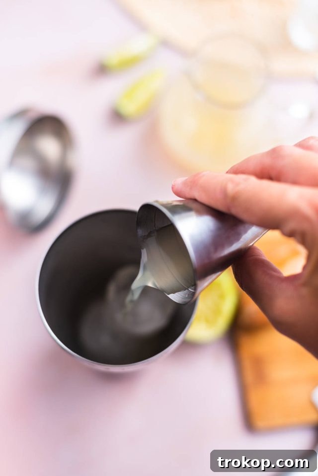 adding ingredients in the cocktail shaker for the Kamikaze