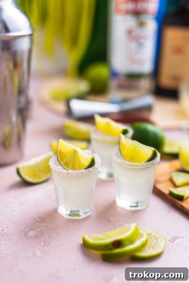 kamikaze shots with lime wedges as garnish