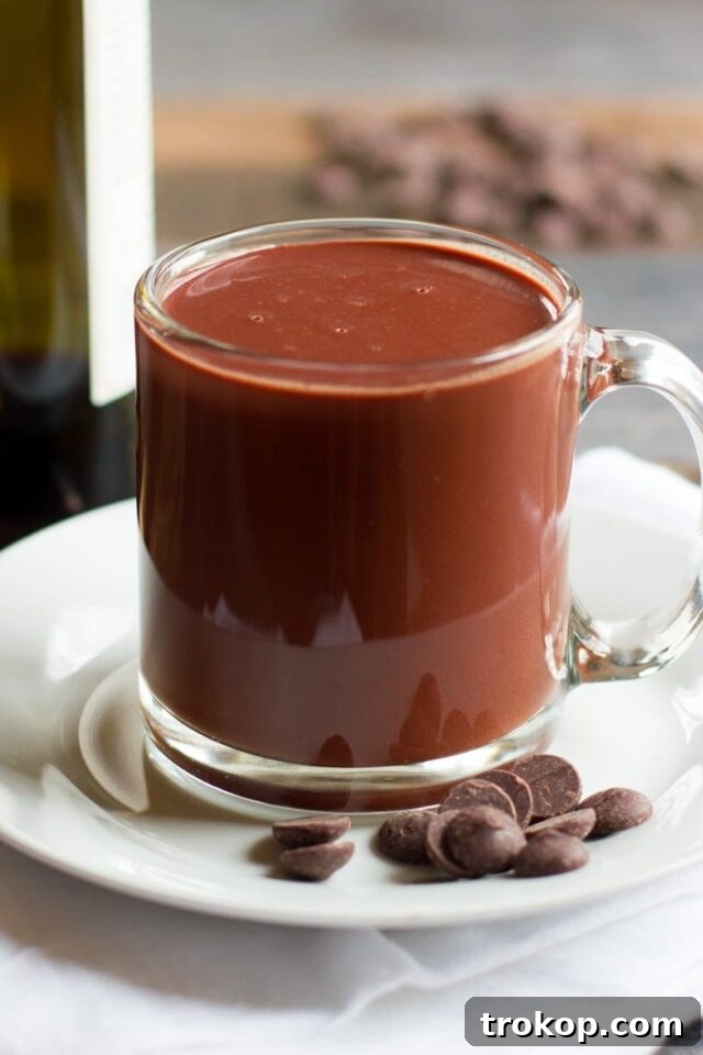25 Easy & Festive Christmas Cocktails for Holiday Merriment 17 Red Wine Hot Chocolate, served in a mug with whipped cream and chocolate shavings.