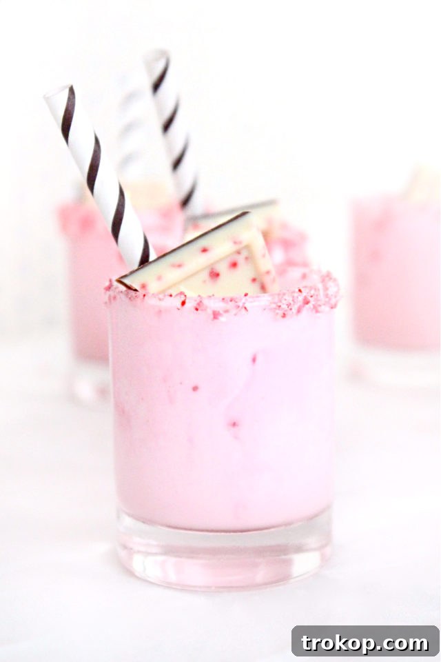 25 Easy & Festive Christmas Cocktails for Holiday Merriment 20 Peppermint Eggnog Milkshake Shots in small glasses, topped with whipped cream and crushed peppermint.