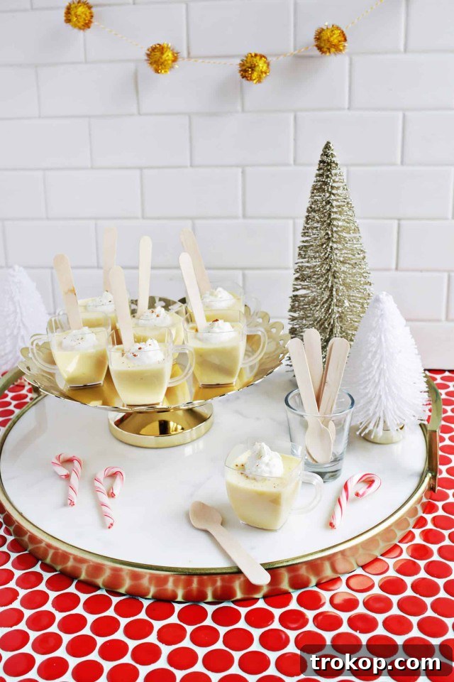25 Easy & Festive Christmas Cocktails for Holiday Merriment 22 Egg Nog Jello Shots for Christmas cocktail recipes, topped with whipped cream and sprinkles.