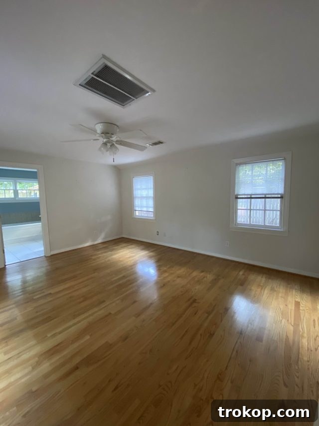Before photo of the dark and low-ceilinged primary bedroom in the Heights home, showing its original unrenovated state by Ashley Rose of Sugar & Cloth.