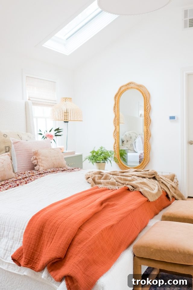 Modern yet cozy cottage bedroom styling, featuring plush bedding, minimalist decor, and ample natural light by Ashley Rose of Sugar & Cloth.