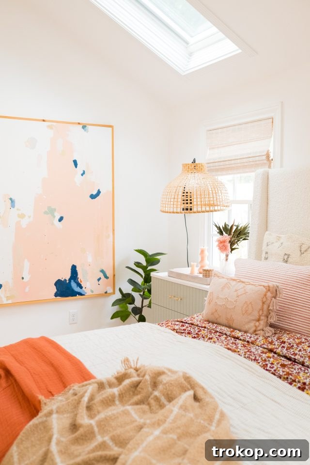 Bedroom decor accessories warming up the cottage bedroom, including textured throws, decorative pillows, and unique artwork by Ashley Rose of Sugar & Cloth.