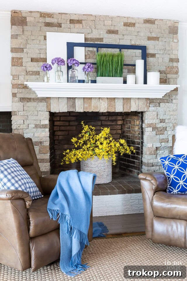Empty fireplace adorned with a vibrant bouquet of flowers.