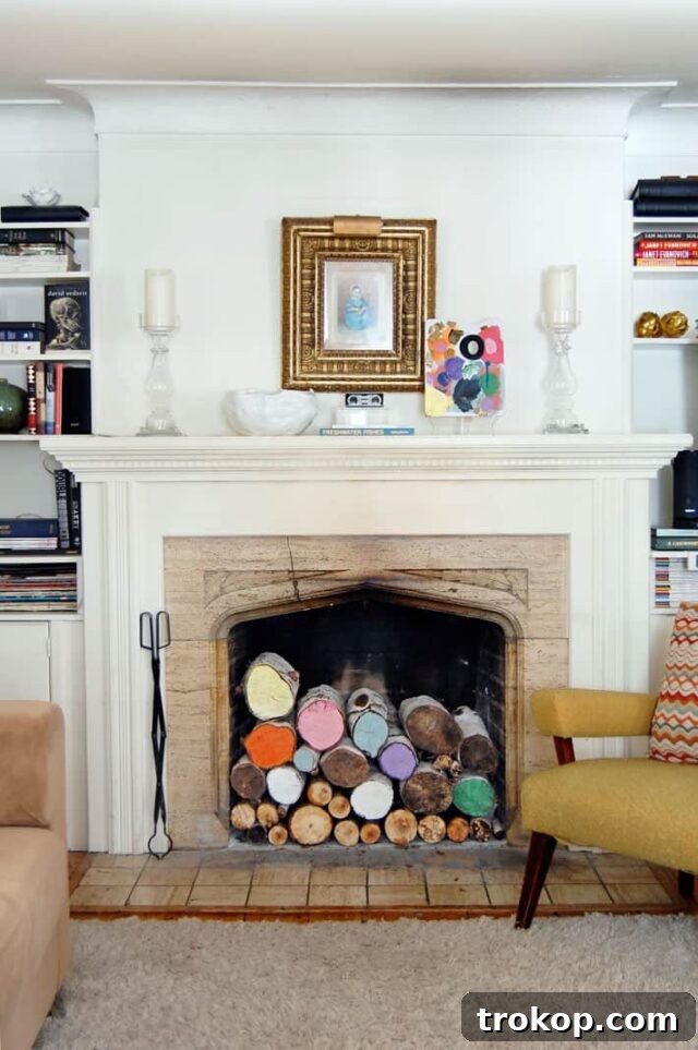 Stacked logs inside an empty fireplace, a timeless decor idea.