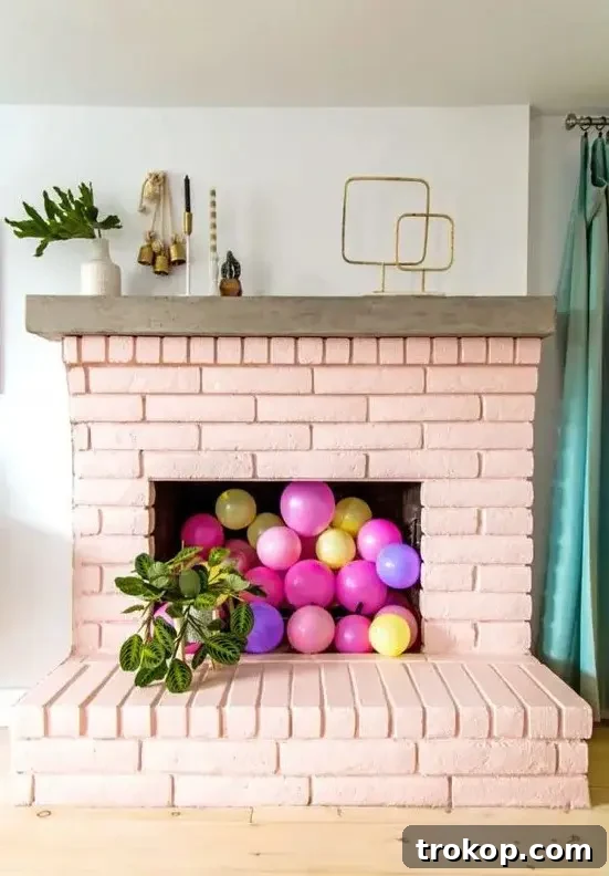Empty fireplace filled with colorful balloons for a festive look.