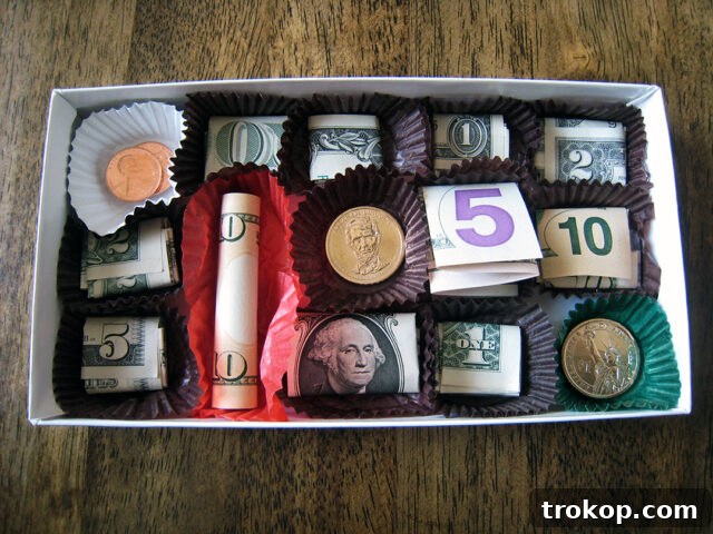 Chocolate Box of Money, with folded bills in chocolate compartments
