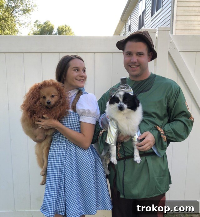 22 Pawsome Matching Halloween Costumes for Couples and Their Dogs 12 Wizard of Oz group Halloween costume with Dorothy, the Tin Man, and Toto (dog) for a couple and their pet.